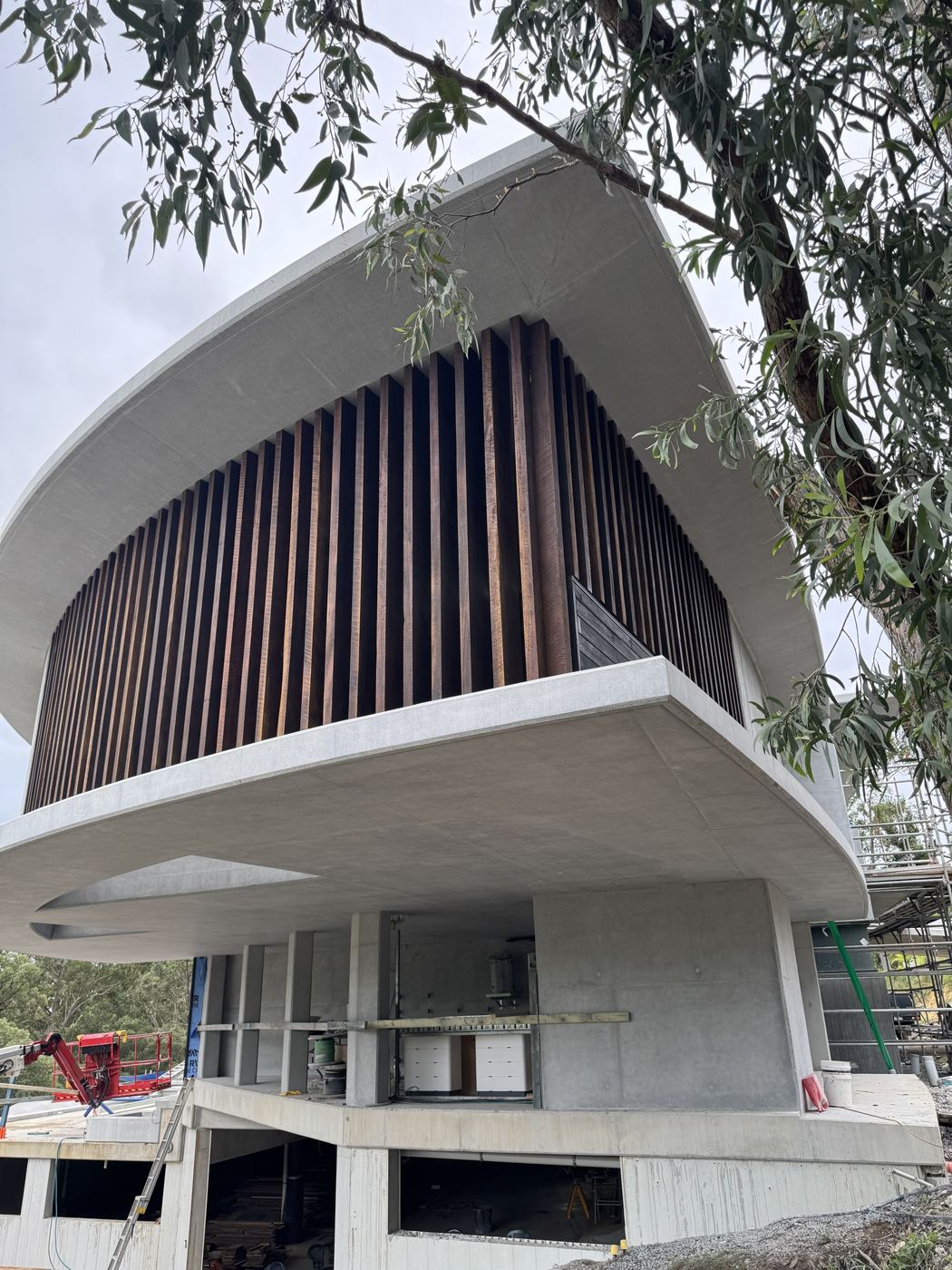 Hardwood battens wrapping the upper level of a concrete home