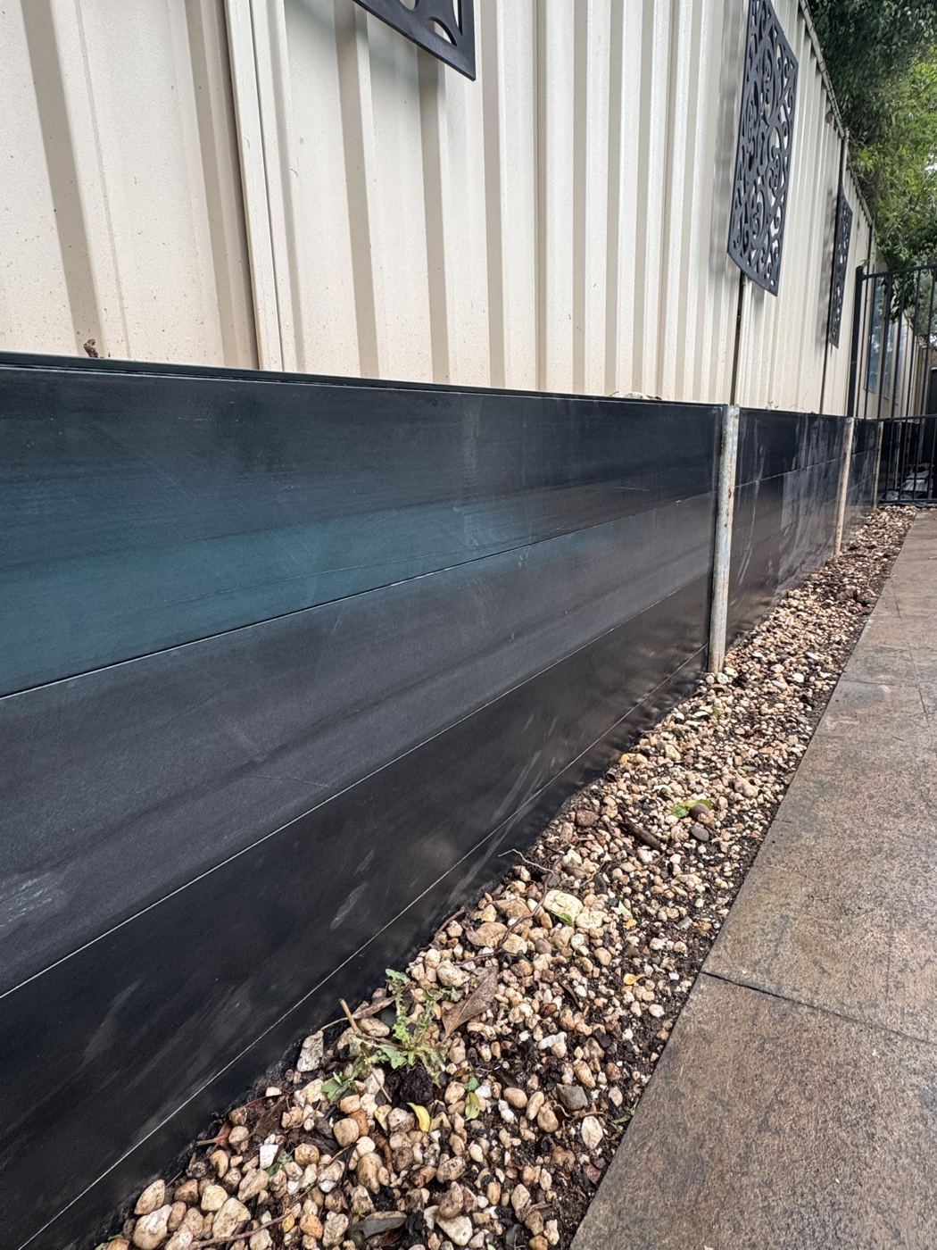Close detail of a black Ezzy Fit sleeper retaining wall