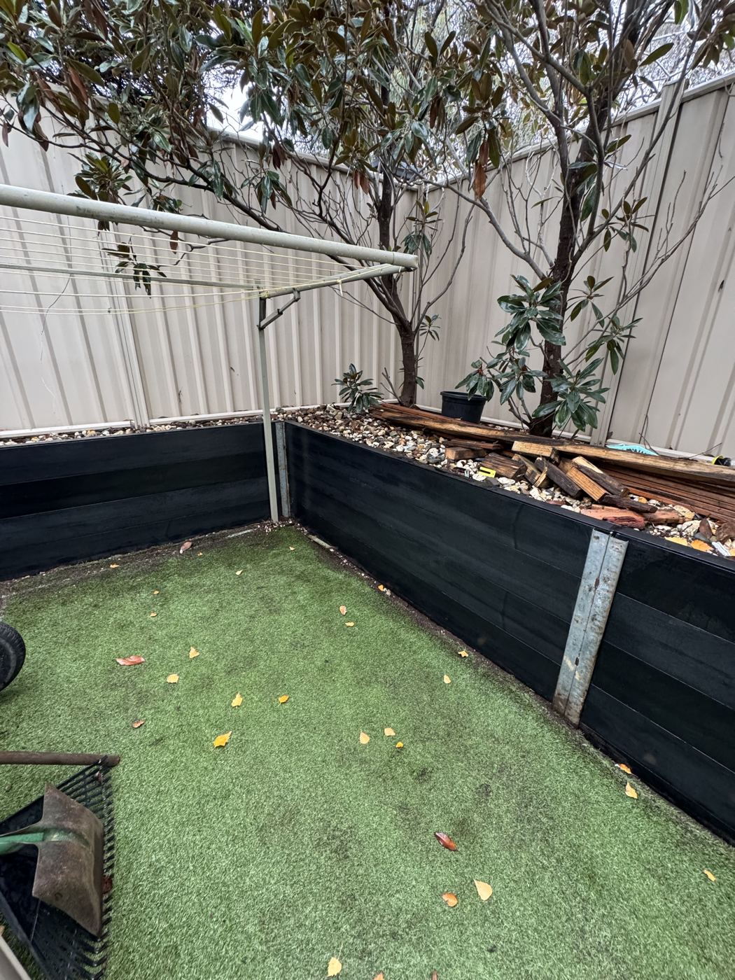 Ezzy Fit sleeper raised garden beds in a backyard corner